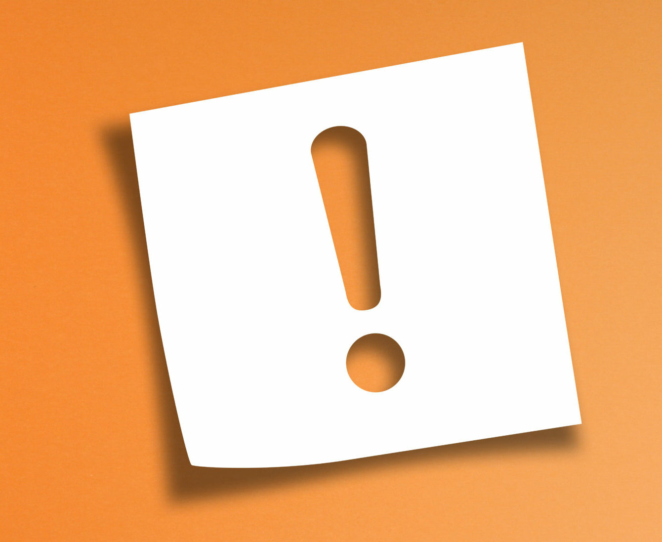 Note paper with exclamation mark on panoramic orange background